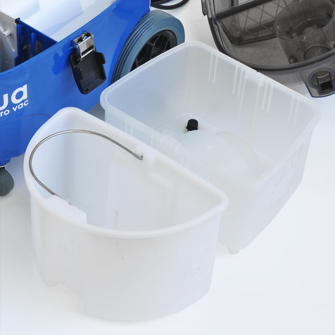 Components of Aqua Pro Vac Extractor, showing the waste and clean water tanks with carrying handles next to the machine.