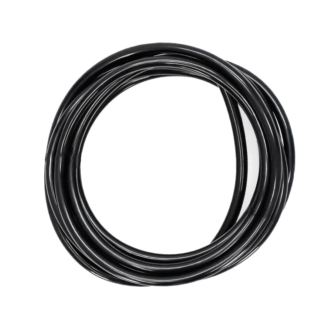 Top-down view of a black water hose neatly arranged in a circular loop.